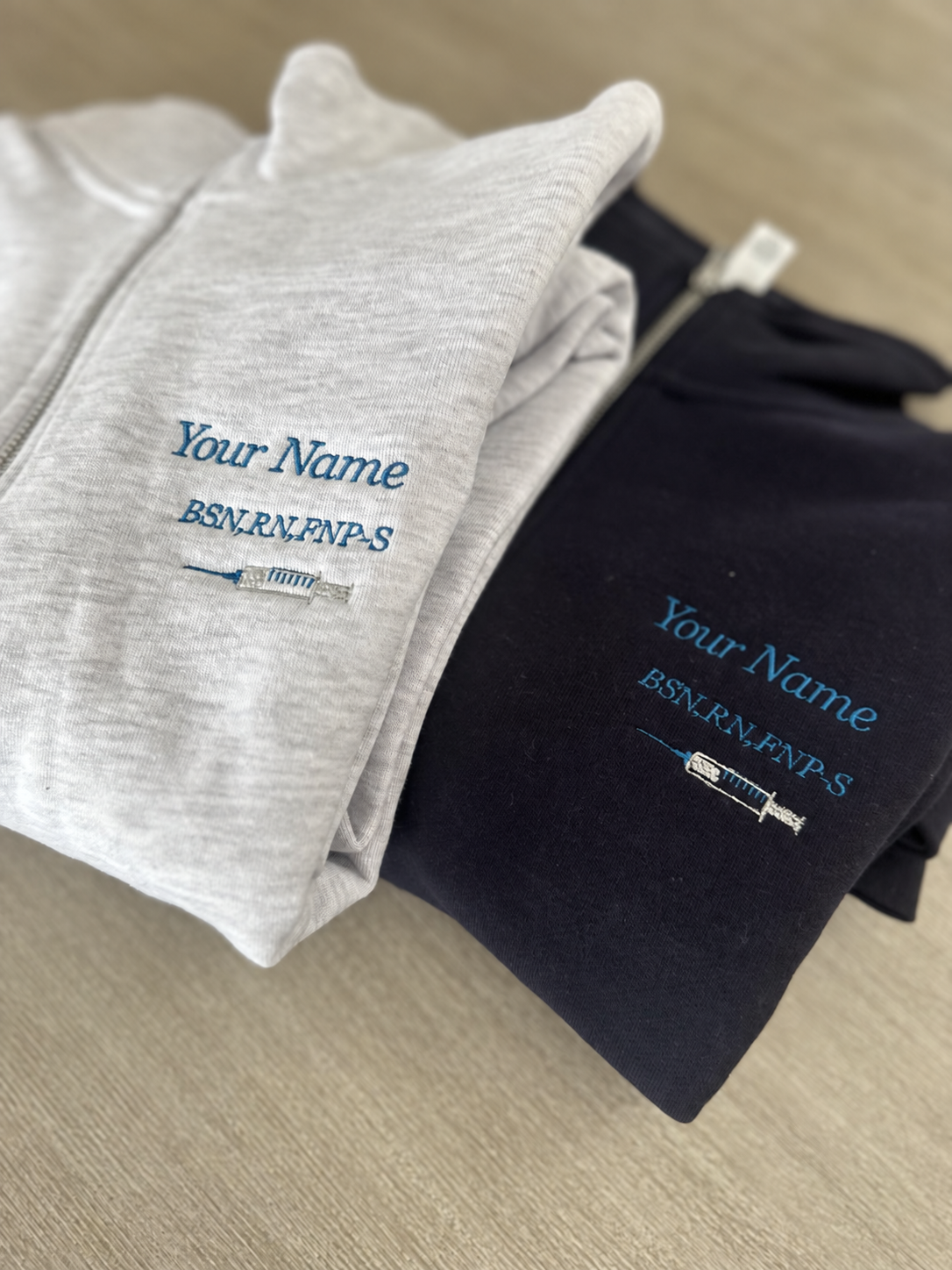 Personalized nurse quarter-zip with name, credentials and syringe embroidery