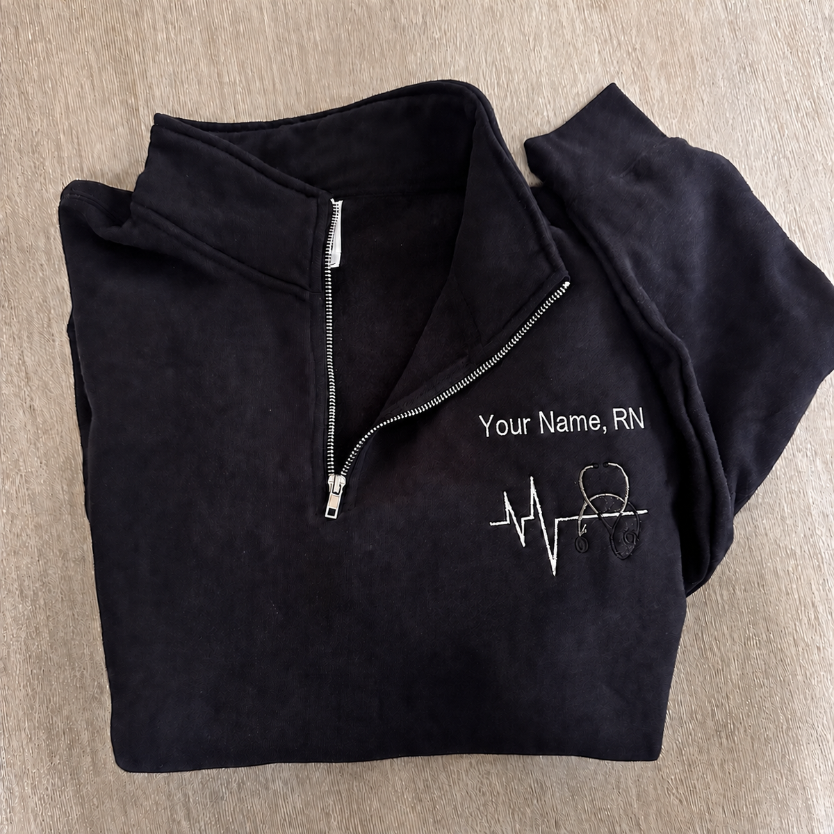 Custom nurse quarter-zip with embroidered name and credentials
