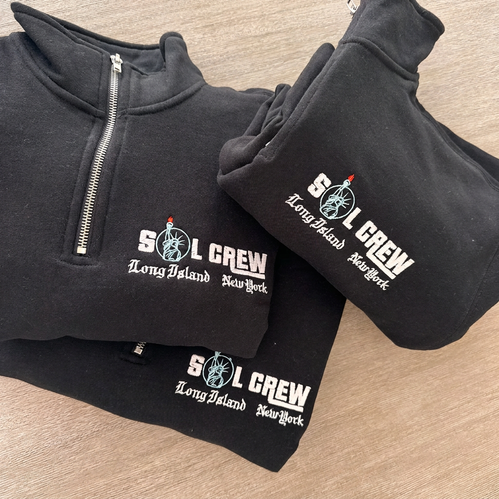 SOL CREW logo embroidery close-up on a quarter-zip