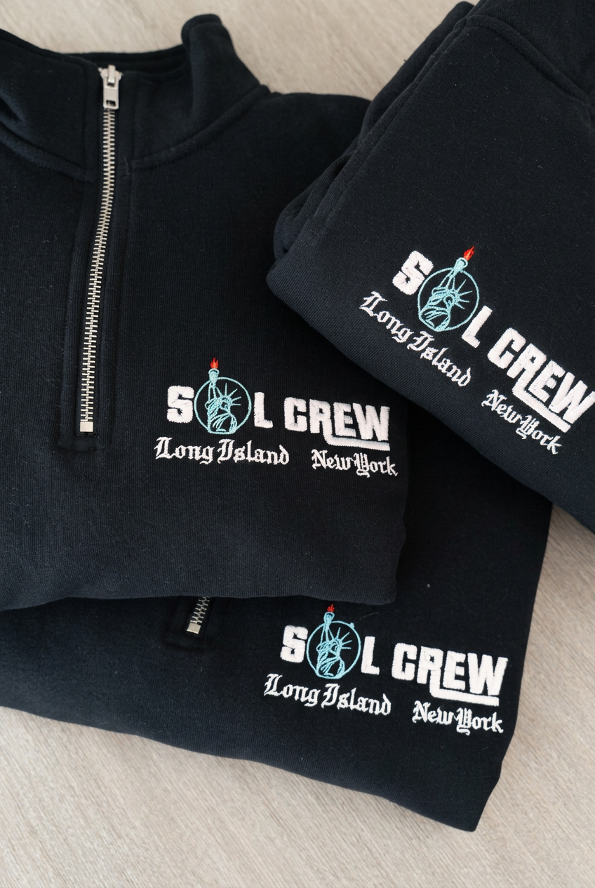 Custom SOL CREW logo embroidered on a dark quarter-zip pullover