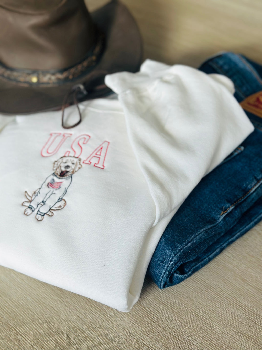 Folded USA dog sweatshirt styled with denim