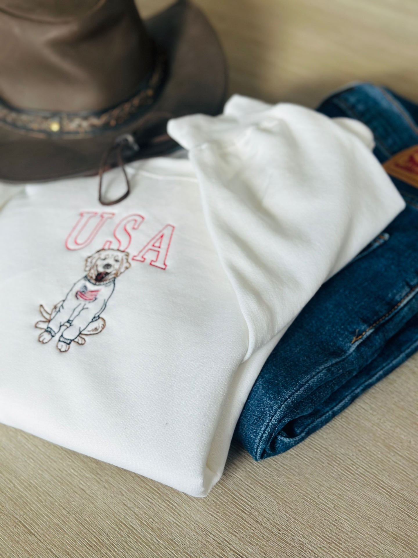 Folded USA dog sweatshirt styled with denim
